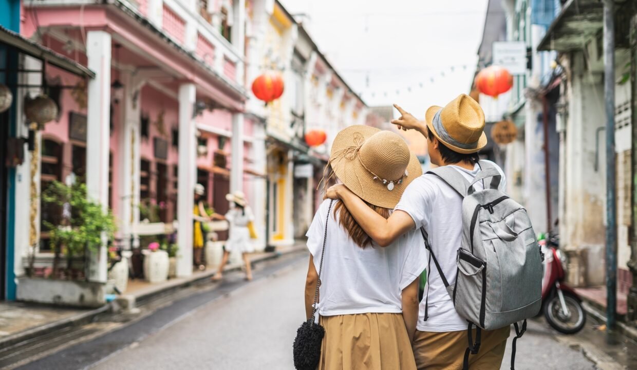 Young couple traveler walking at Phuket old town in Thailand